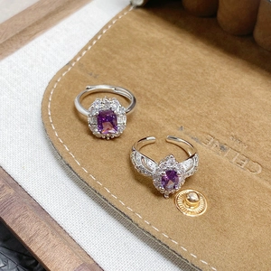 Macro shot of rectangular and oval purple zircon rings with silver metal settings
