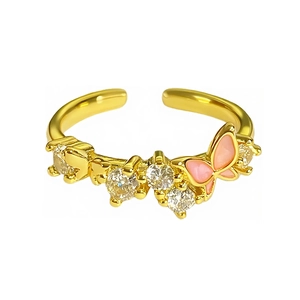 Adjustable gold butterfly ring with pink enamel and white zircon stones on white background