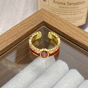 Detail view of vintage enamel flower ring with pink gemstone and gold finish