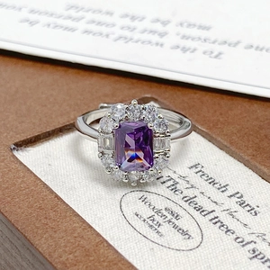Macro shot of luxury rectangular purple zircon ring with shimmering crystal halo detail