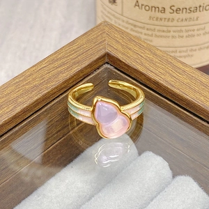Detail of vintage golden adjustable ring with pink Wulou gourd and floral enamel