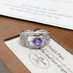 Detail of adjustable silver ring with purple zircon center and double-layered pavé band