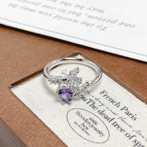 Detailed macro view of purple heart-shaped zircon ring with sparkling side stones