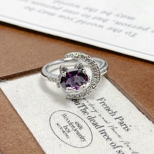Detailed close-up of cat-shaped purple zircon ring with crescent moon and diamond accents