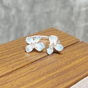 Detailed macro view of 925 silver open ring featuring blue enamel flowers and tiny zircons