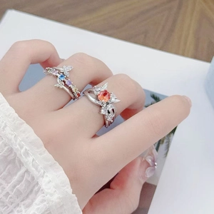 Detail of silver open rings set with colorful zircon stones and butterfly design