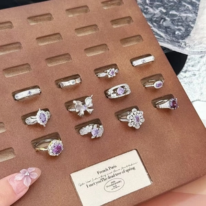 Adjustable silver rings set with purple zircon gemstones in butterfly and floral designs