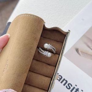 Close-up of silver-tone open ring with white pearls and pavé set cubic zirconia