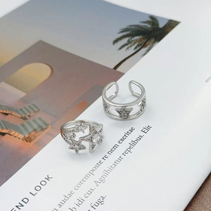 Detail of silver star rings with micro-set zircons and hollow star-shaped design