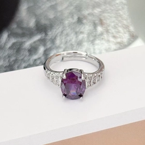 Macro detail of oval purple zircon ring with multi-row crystal pavé and silver finish