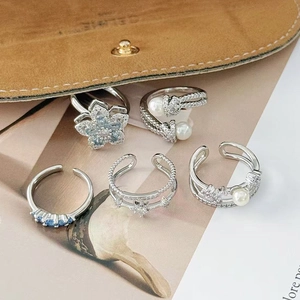 Detail of five-piece silver ring set with light blue zircon and elegant flower designs