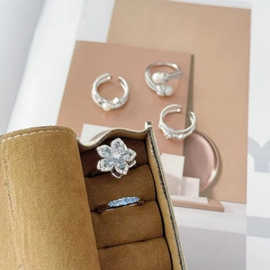 Detailed view of luxury flower rings with blue zircon in a premium brown velvet jewelry box
