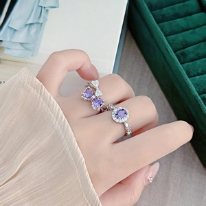 Silver rings featuring a purple heart butterfly bow and oval gemstone with tiny diamonds