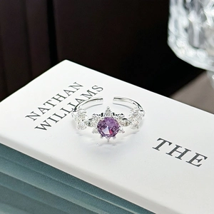 Detailed close-up of adjustable silver ring with purple gemstone and floral zircon cluster