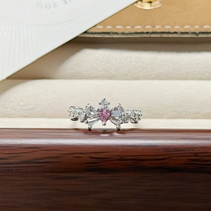 Macro shot of silver crown ring with pink heart stone and white marquise crystals