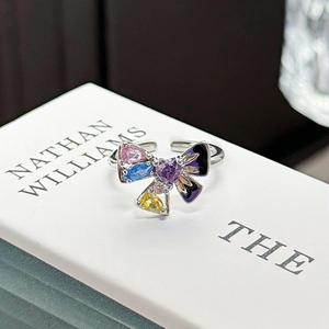 Close-up of a silver butterfly open ring with colorful crystals and black enamel details