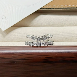 Detail view of silver double-layered open ring with sparkling stars and zircon stones