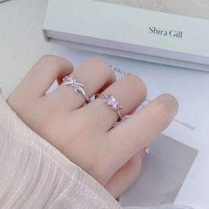 Nahaufnahme von eleganten Schleifenringen aus Silber mit rosa Zirkonia an der Hand