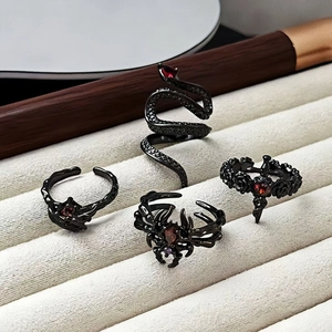 Gothic 4-piece ring set with spider, snake, and rose motifs featuring red gems
