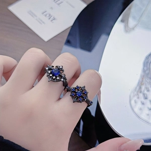 Detailed macro view of retro black gothic rings set with blue gemstone and diamonds