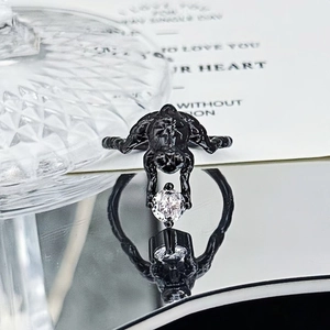 Detailed macro view of black punk spider ring holding a brilliant round white zircon stone