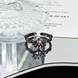 Macro shot of gothic black alloy ring with purple crystal and adjustable open band