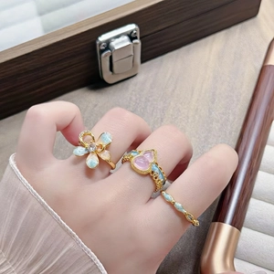 Vintage Emaille Blumen und Herz Ringe in Goldoptik getragen an der Hand von Frauen