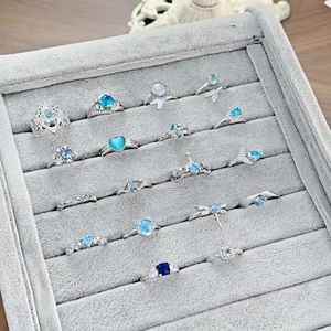 Collection of silver luxury rings with sea blue zircon in various delicate shapes