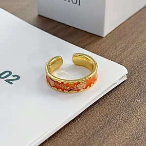 Detailaufnahme des roten Emaille-Rings mit weißem Pflaumenblütenmuster und Goldband
