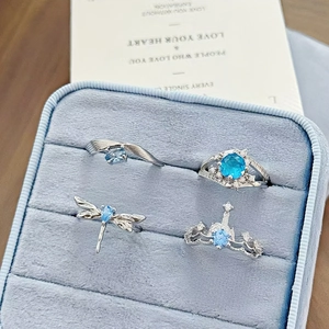Luxury set of four silver rings with blue zircon stones in a velvet gift box
