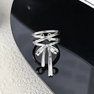 Detailed view of multilayer silver bow ring with polished finish and adjustable band