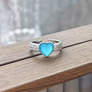 Detailed macro view of heart-shaped blue zircon on adjustable silver textured band