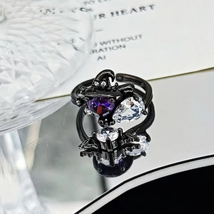 Macro shot of gothic wizard ring with purple heart zircon and black plating detail