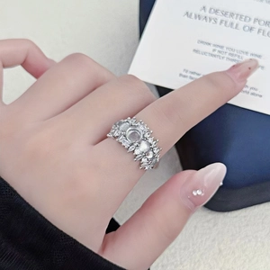 Macro detail of silver moonstone ring with zircon cluster on woman's index finger
