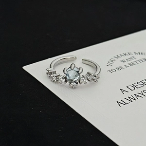Macro shot of adjustable silver ring with moonstone and cubic zirconia clusters