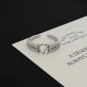 Macro detail of silver adjustable moonstone ring with pave cubic zirconia accents