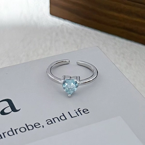 Detalle macro de piedra de circón azul en forma de corazón en anillo de plata ajustable