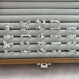 Collection of silver adjustable rings with pink zircon in butterfly and heart shapes