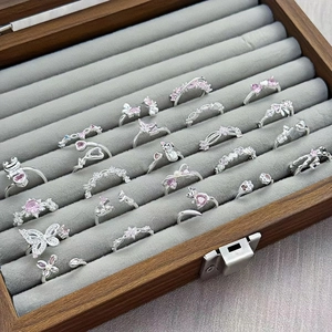 Silver adjustable rings with pink zircon in butterfly and cat designs on velvet tray