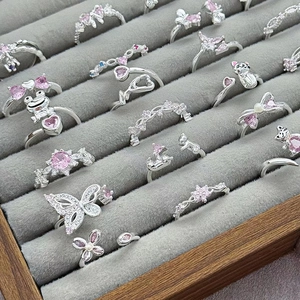 Selection of adjustable silver rings featuring pink zircon animals and floral motifs