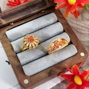 Close-up of vintage gold rings with orange zircon stones in a velvet jewelry box