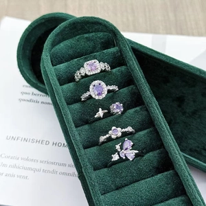 Detailed close-up of a 5-piece silver ring set with purple zircons in a velvet box