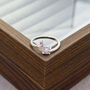 Detail view of silver butterfly ring featuring pink marquise stones and small white diamonds