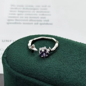 Macro shot of silver adjustable ring with purple zircon and irregular texture