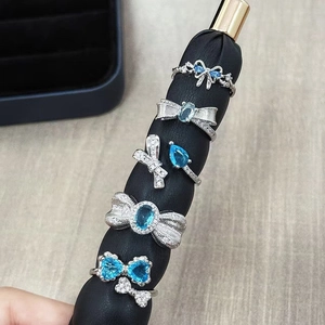 Luxurious silver bowknot ring set with light blue gemstones and zircon butterfly accents