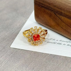 Macro detail of vintage floral ring with orange square zircon and sparkling crystal petals