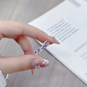 Close-up of double layer silver ring with marquise purple zircons worn on hand