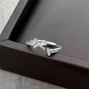 Macro shot of sparkling zircon bowtie ring with polished silver finish and micro-pave setting