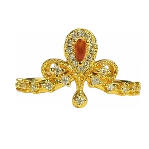 Vintage gold crown ring with orange zircon and white accents on a white background