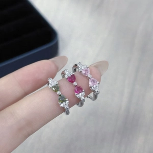 Detailed close-up of heart-shaped colored gemstone rings with cubic zirconia accents
